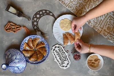 Hand stuffing Qatayef, nuts, oriental Arabic sweets, Ramadan sweets