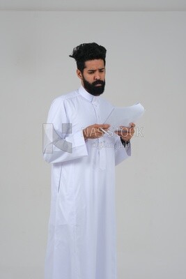 Saudi man taking notes on work papers and files, preparing reports and work tasks, business feasibility study, white background, Saudi model