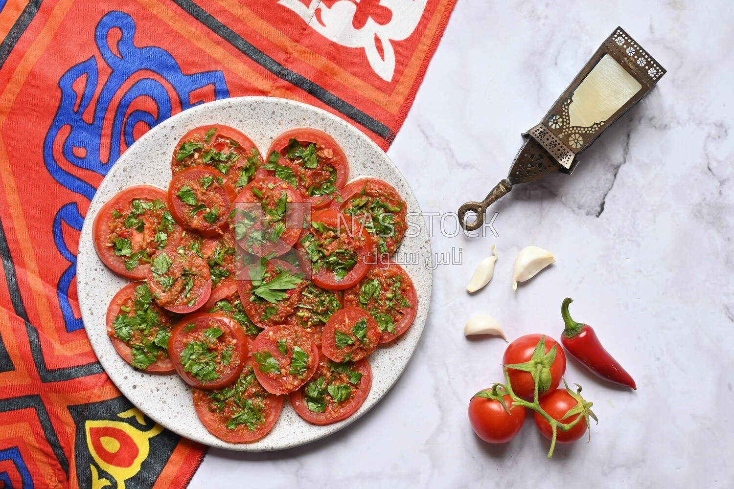 Plate of pickled tomatoes with parsley, besides garlic, red pepper, Egyptian pickles, Arab restaurants