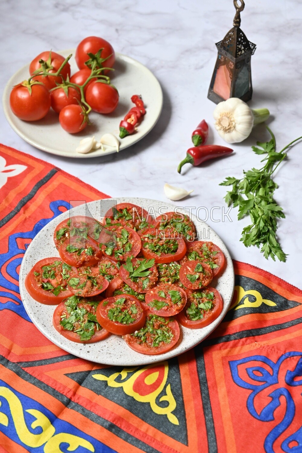 Plate of pickled tomatoes with parsley, besides garlic, red pepper, Egyptian pickles, Arab restaurants