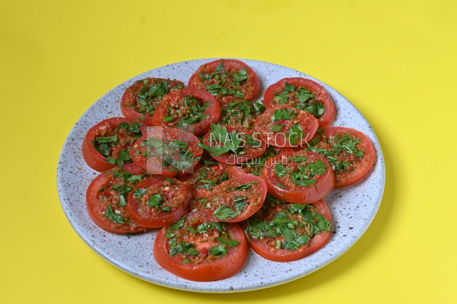 Plate of pickled tomatoes with parsley, Egyptian pickles, Arab restaurants