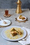 Baklava with nuts, a cup of tea, a plate of honey, oriental Arabic sweets, Ramadan sweets