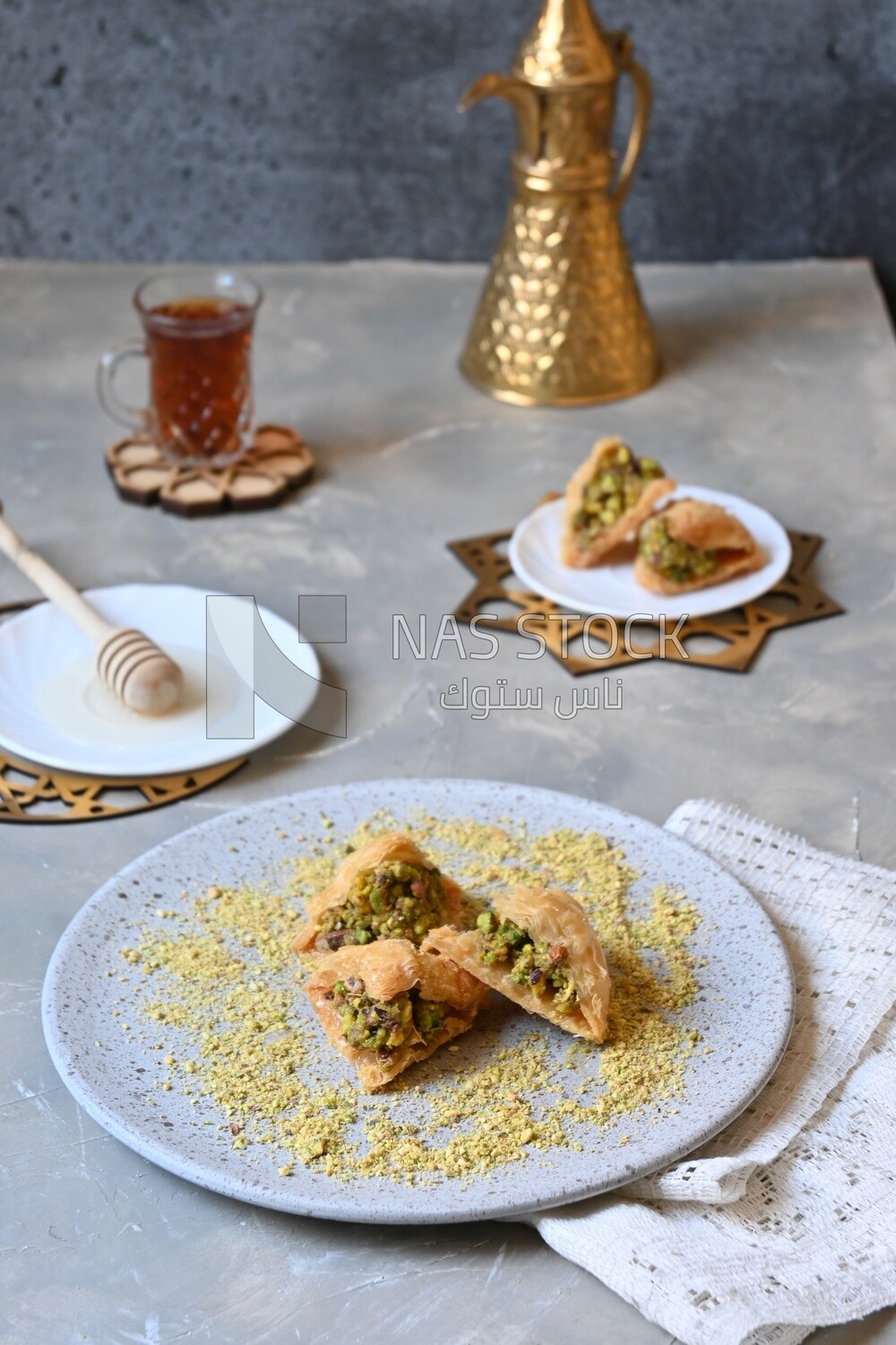 Baklava with nuts, a cup of tea, a plate of honey, oriental Arabic sweets, Ramadan sweets