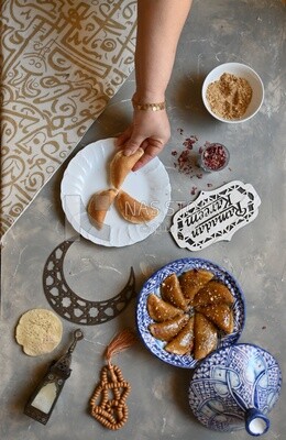 Hand stuffing Qatayef, nuts, oriental Arabic sweets, Ramadan sweets