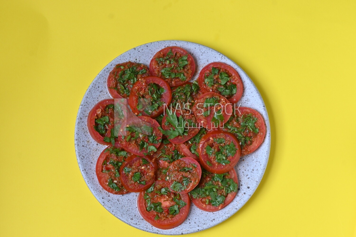 Plate of pickled tomatoes with parsley, Egyptian pickles, Arab restaurants