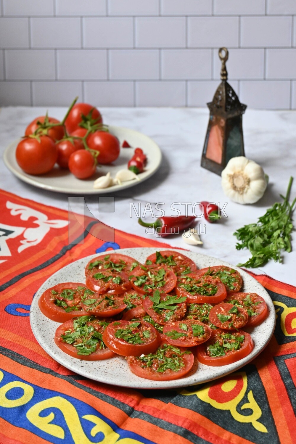 Plate of pickled tomatoes with parsley, besides garlic, red pepper, Egyptian pickles, Arab restaurants