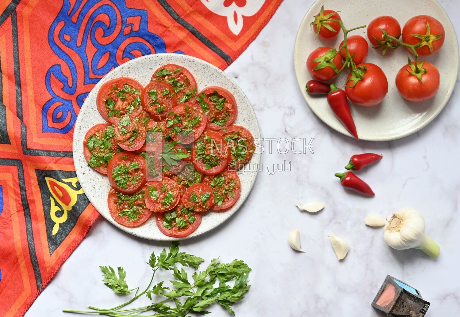 Plate of pickled tomatoes with parsley, besides garlic, red pepper, Egyptian pickles, Arab restaurants