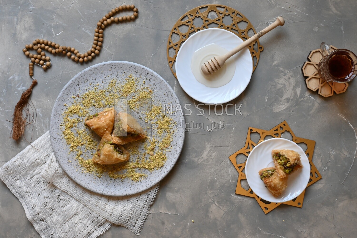 Baklava with nuts, a cup of tea, a plate of honey, oriental Arabic sweets, Ramadan sweets