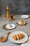 Baklava with cream in it, a cup of tea, a plate of honey, oriental Arabic sweets, Ramadan sweets