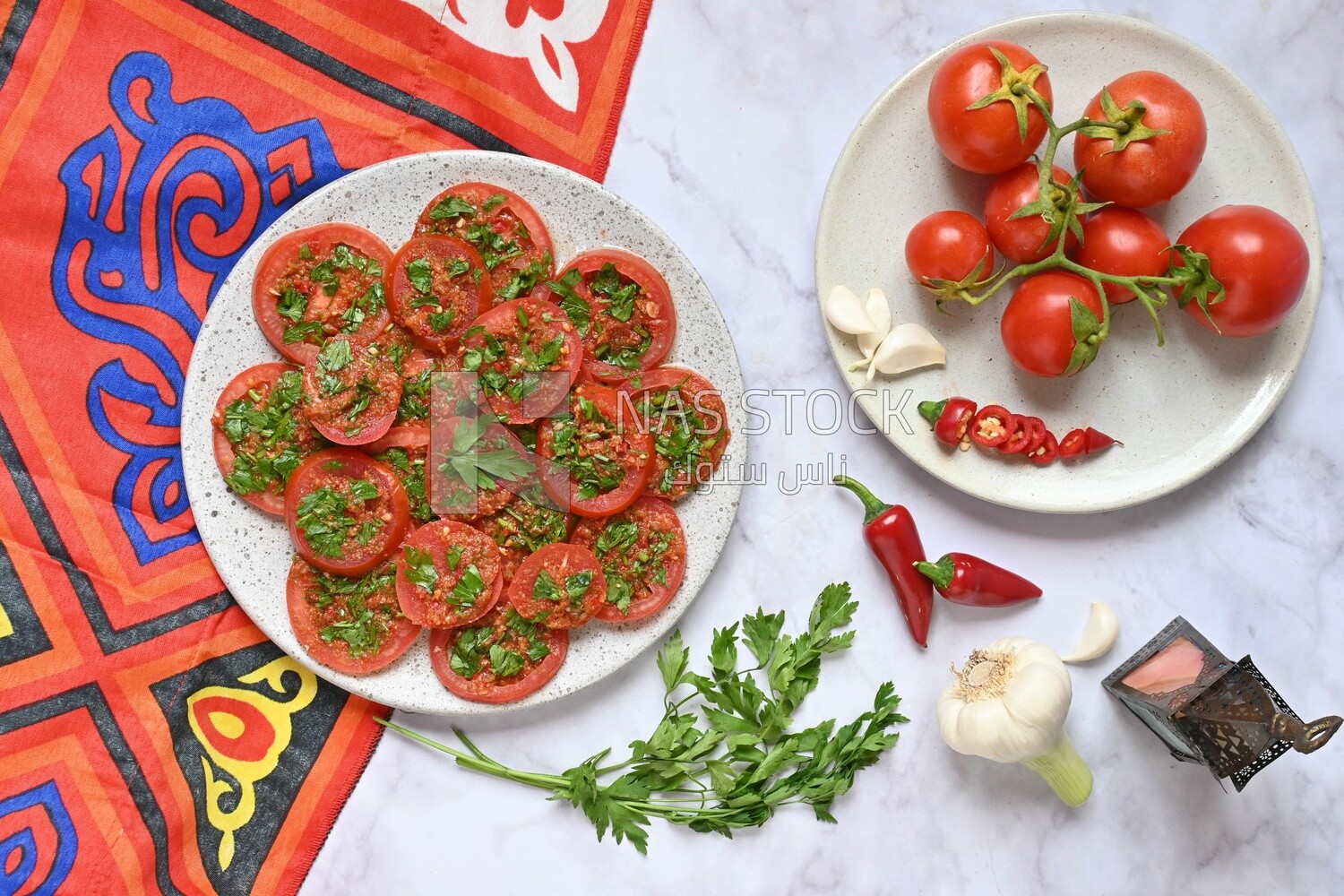 Plate of pickled tomatoes with parsley, besides garlic, red pepper, Egyptian pickles, Arab restaurants