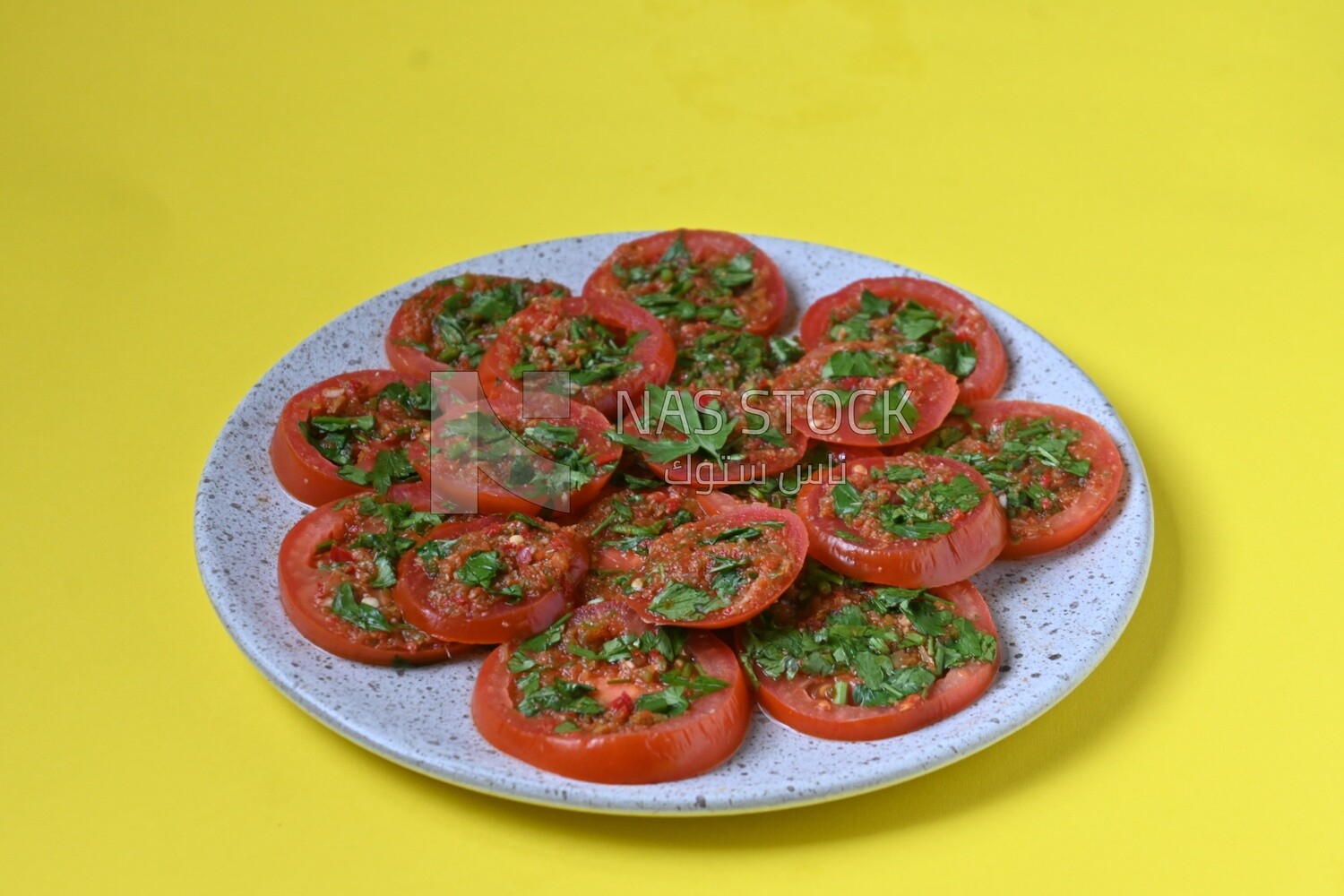 Plate of pickled tomatoes with parsley, Egyptian pickles, Arab restaurants