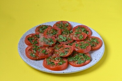 Plate of pickled tomatoes with parsley, Egyptian pickles, Arab restaurants