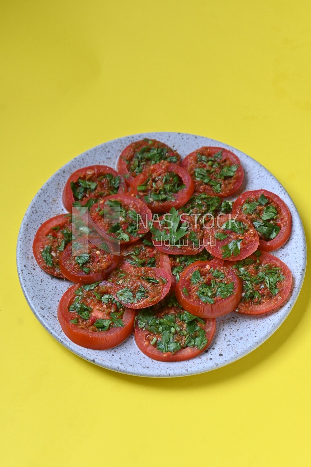 Plate of pickled tomatoes with parsley, Egyptian pickles, Arab restaurants