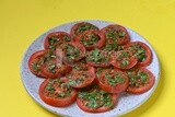 Plate of pickled tomatoes with parsley, Egyptian pickles, Arab restaurants