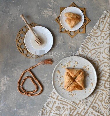 Baklava with nuts, a plate of honey, oriental Arabic sweets, Ramadan sweets
