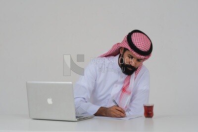 Saudi man sitting in front of a laptop writing notes,  a cup of tea, business feasibility study, white background, Saudi model