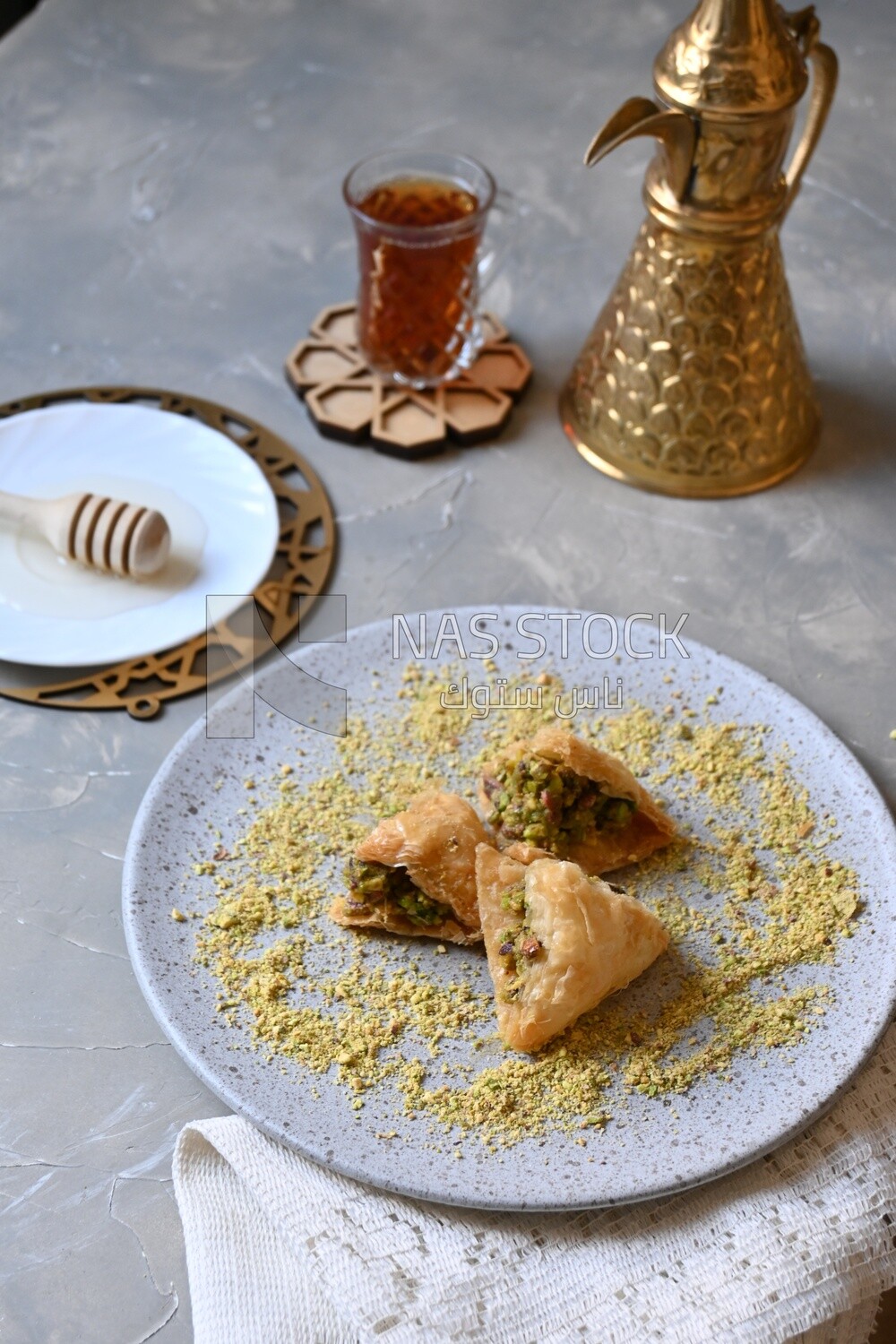 Baklava with nuts, a cup of tea, a plate of honey, oriental Arabic sweets, Ramadan sweets