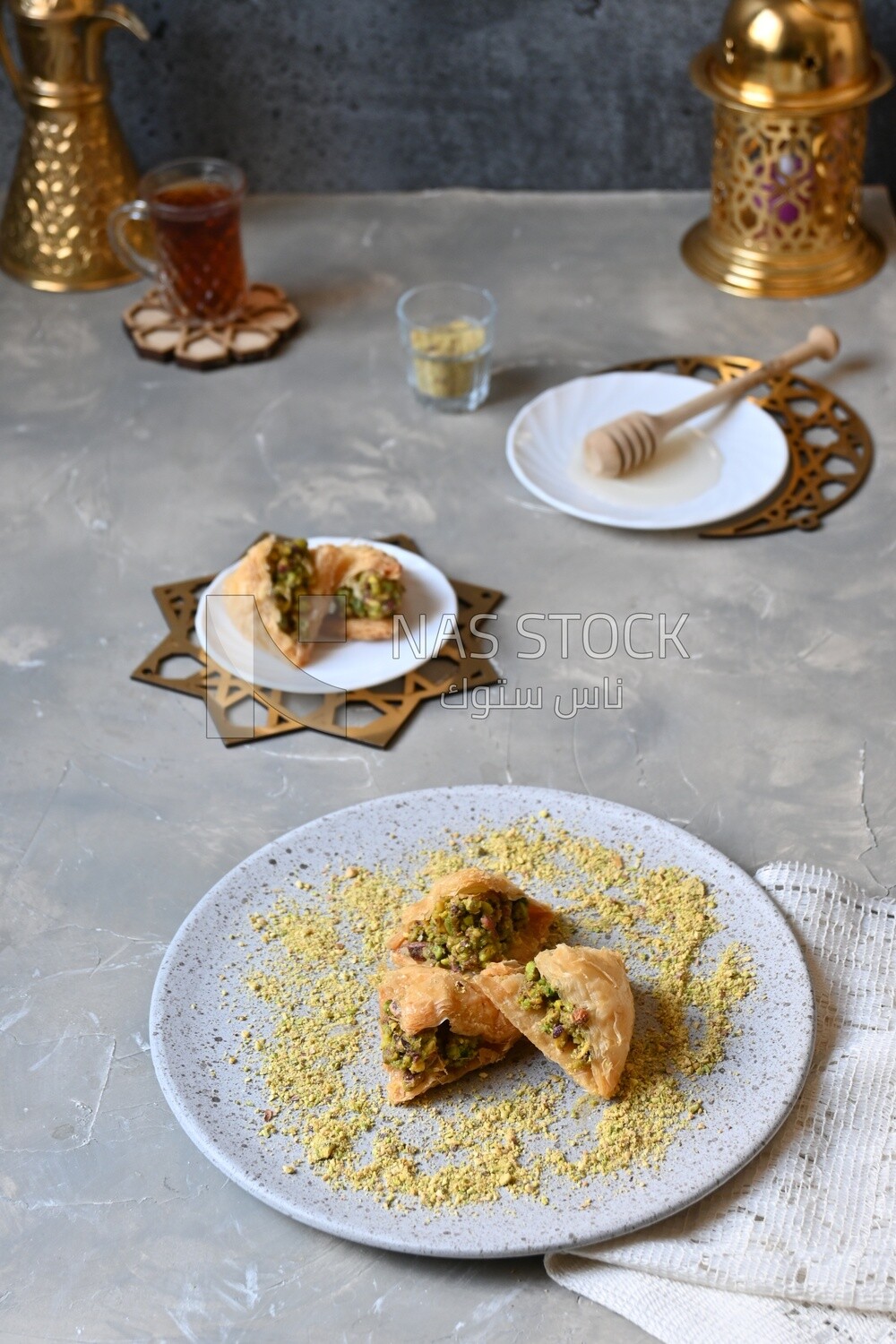 Baklava with nuts, a cup of tea, a plate of honey, oriental Arabic sweets, Ramadan sweets