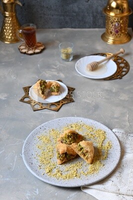 Baklava with nuts, a cup of tea, a plate of honey, oriental Arabic sweets, Ramadan sweets