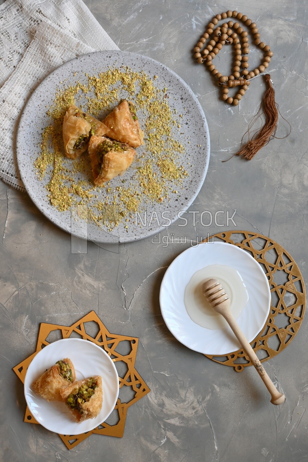 Baklava with nuts, a plate of honey, oriental Arabic sweets, Ramadan sweets