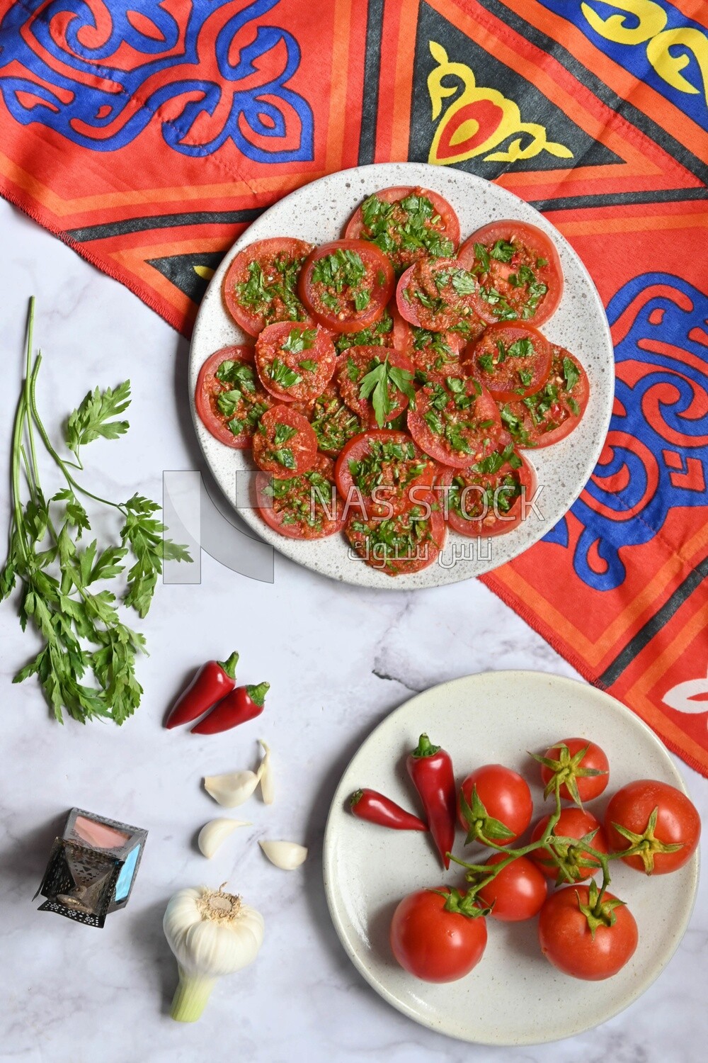 Plate of pickled tomatoes with parsley, besides garlic, red pepper, Egyptian pickles, Arab restaurants