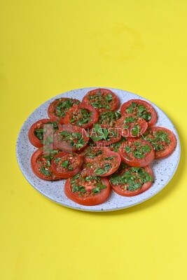 Plate of pickled tomatoes with parsley, Egyptian pickles, Arab restaurants