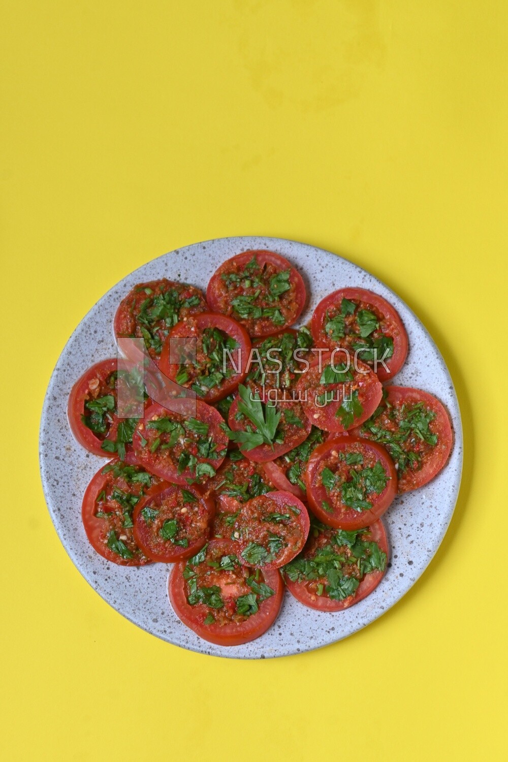 Plate of pickled tomatoes with parsley, Egyptian pickles, Arab restaurants