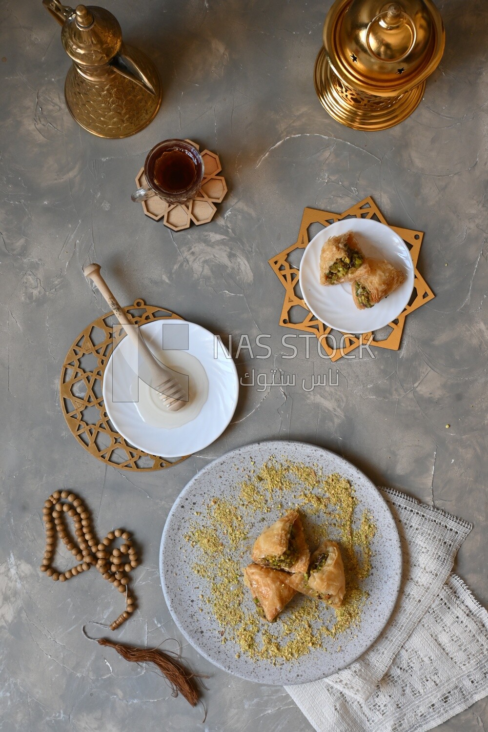 Baklava with nuts, a cup of tea, a plate of honey, oriental Arabic sweets, Ramadan sweets