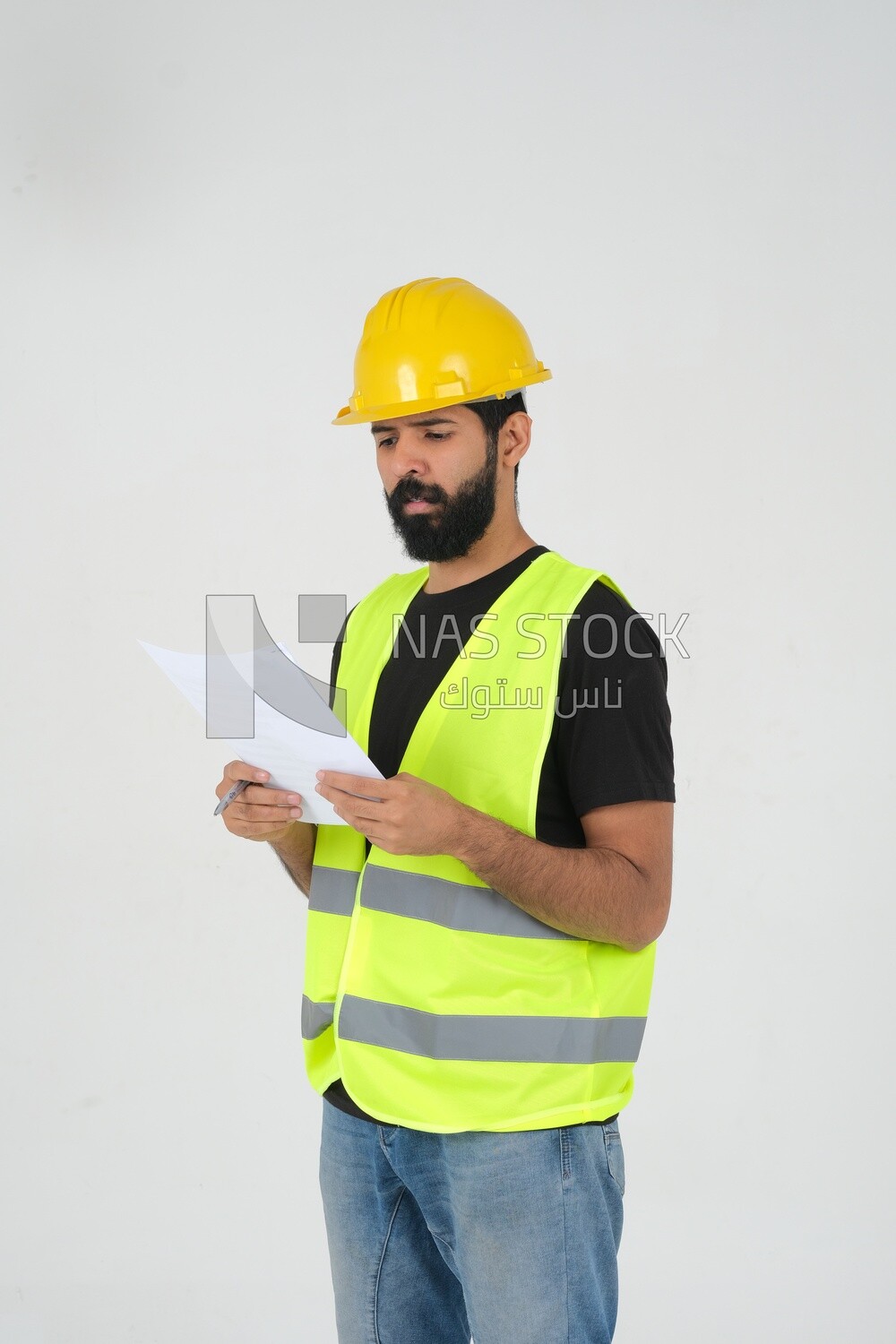 Saudi engineer wearing a work helmet and protective jacket, writing and taking notes, engineering professions and jobs, white background, Saudi model