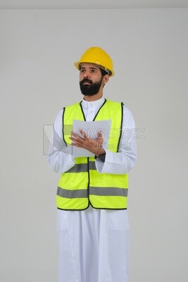 Saudi engineer wearing a work helmet and protective jacket, writing and taking notes, engineering professions and jobs, white background, Saudi model