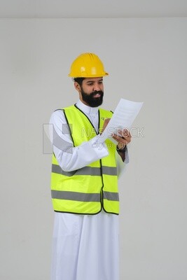 Saudi engineer wearing a work helmet and protective jacket, writing and taking notes, engineering professions and jobs, white background, Saudi model