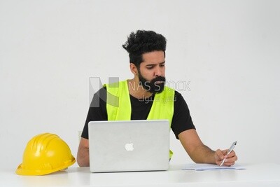 Saudi engineer wearing a work hat sitting and working on the laptop, engineering professions and jobs, white background, Saudi model