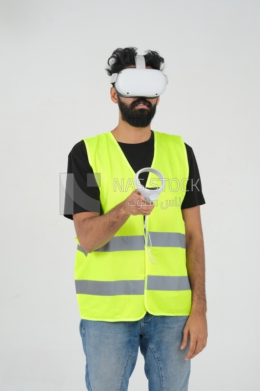 Saudi engineer wearing a safety vest, use the VR of 3D hologram