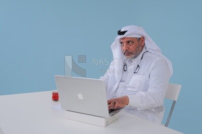 Saudi man sitting and working on a laptop, a cup of tea, business feasibility study, Saudi model