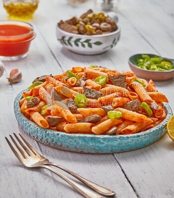 Side view of a dining table containing pasta with liver and appetizers