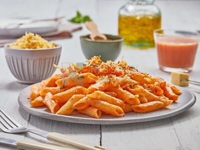 Side view of a plate of pasta with red sauce