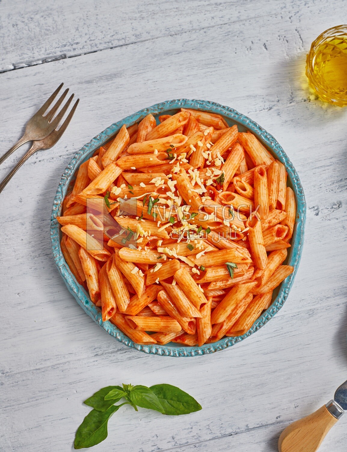 Top view of a plate of pasta with red sauce