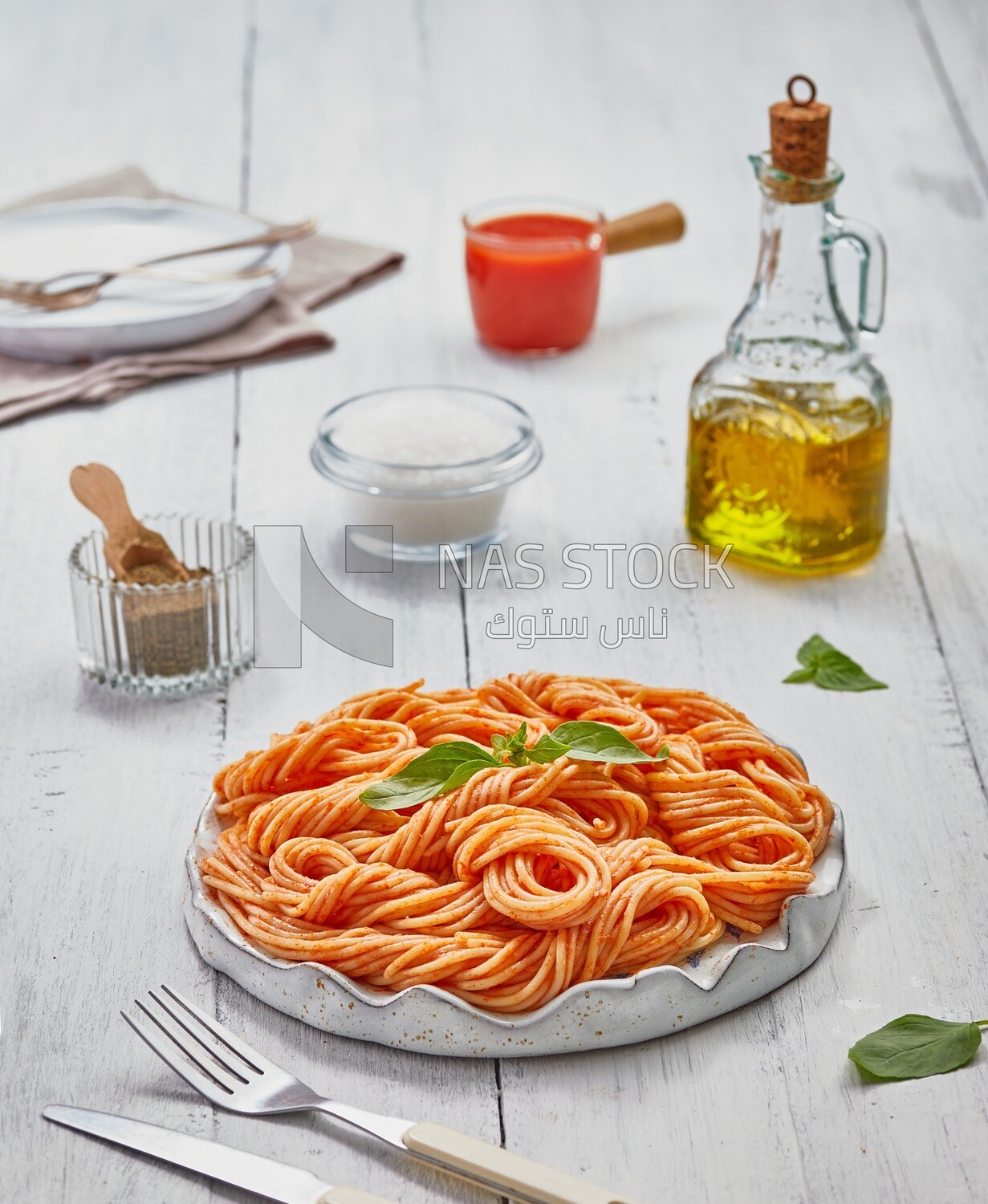 Side view of a plate of spaghetti pasta with red sauce