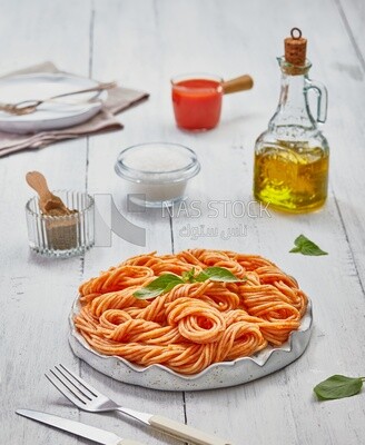 Side view of a plate of spaghetti pasta with red sauce