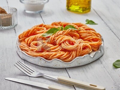 Side view of a plate of spaghetti pasta with red sauce