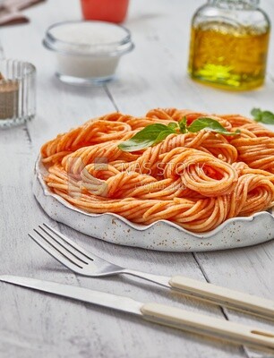 Side view of a plate of spaghetti pasta with red sauce
