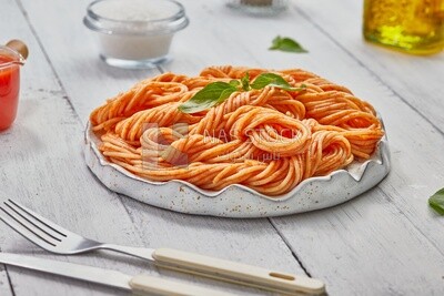 Side view of a plate of spaghetti pasta with red sauce
