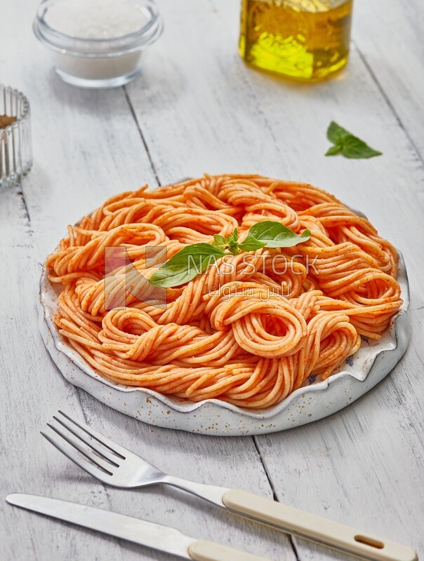 Top view of a plate of spaghetti pasta with red sauce