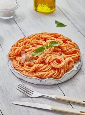 Top view of a plate of spaghetti pasta with red sauce
