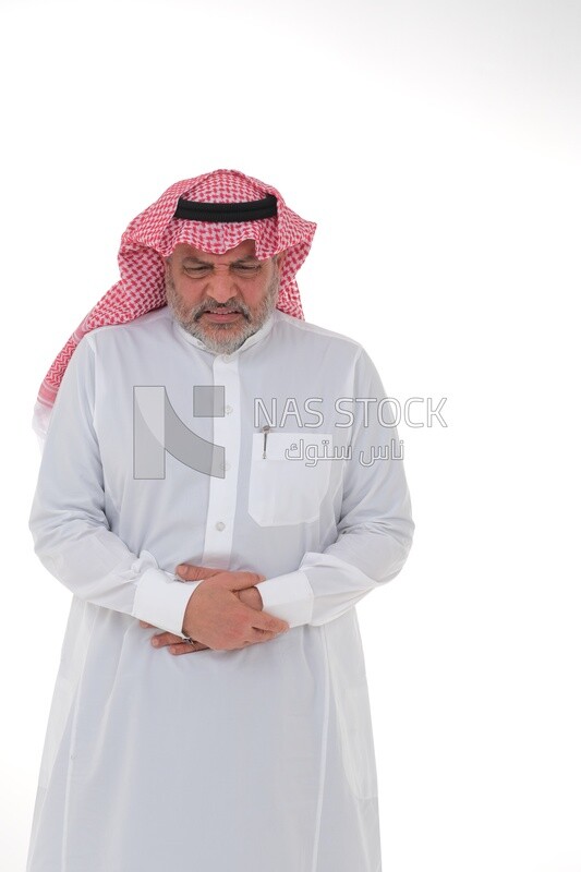 Saudi man placing his hands on his stomach,  abdominal and stomach pain, intestinal disorders, digestive system imbalance, white background