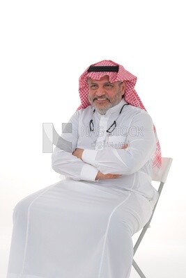 Saudi man wearing a ghutra, sitting on a chair, hands crossed sitting confidently, face and hand gestures indicating happiness and confidence, white background, Saudi model