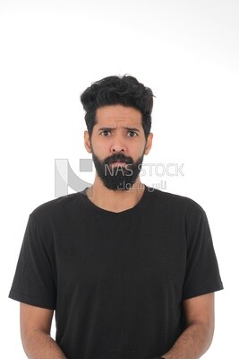 close-up of a Saudi man looking angry, wearing casual clothes, carrying his mobile phone, Saudi model, white background