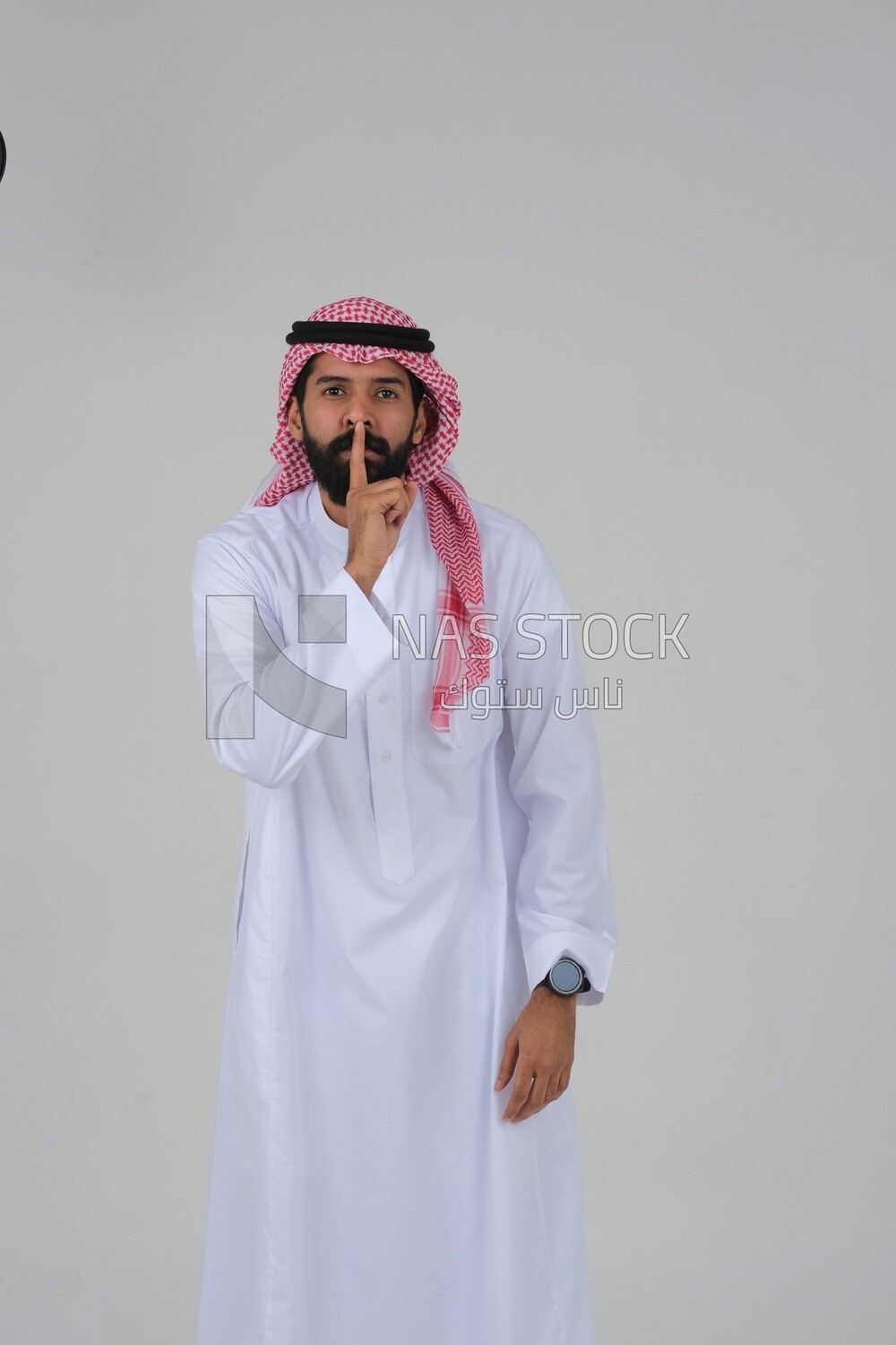 man placing his index finger on his mouth, facial and hand gestures indicating a request for silence, stopping speaking, lowering the volume, threatening, calm and stillness, white background