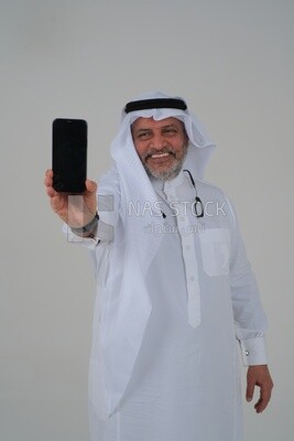 saudi man using a mobile phone, communicating with individuals, online requests and marketing, social relations, using technical devices, white background