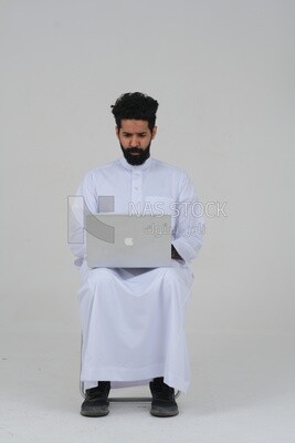 Saudi man sitting in front of a laptop, business feasibility study, white background, Saudi model